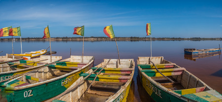 Lac Rose, SenegalL - Feb 02, 2019: Wooden boats on the coast of the Lake Retba. Panoramic view. Africaのeditorial素材