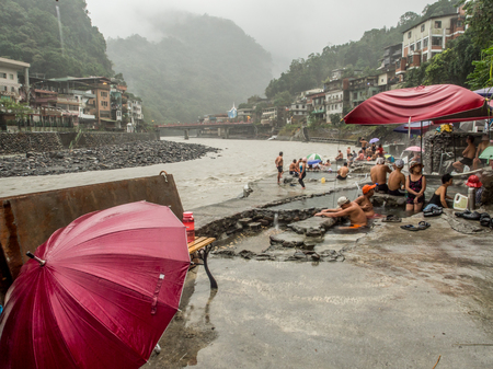 Wulai, Taiwan - October 09, 2016: Public swimming pools with water from hot springs in the rainy day. Asia.のeditorial素材