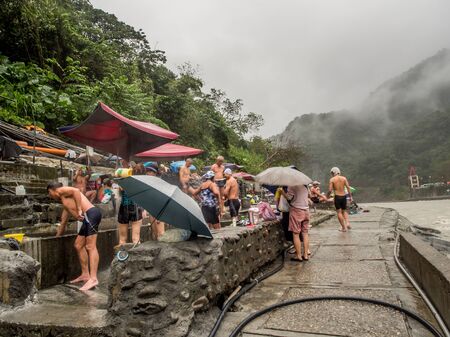 Wulai, Taiwan - October 09, 2016: Public swimming pools with water from hot springs in the rainy day. Asia.のeditorial素材
