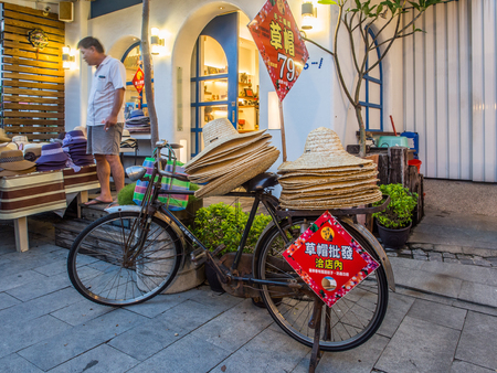 Tainan, Taiwan - October 10, 2016: Typical local bazaar in Taiwan with lots of local products and straw  hats on the bicycleのeditorial素材