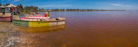 Lac Rose, SenegalL - Feb 02, 2019: Wooden boats on the coast of the Lake Retba. Panoramic view. Africaのeditorial素材