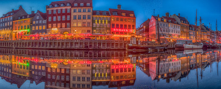 Nyhavn (New Harbour), Copenhagen, Denmark - 14 JMay 2019: Panoramic view of Nyhavn pier with color buildings, ships, yachts and other boats in the Old Town of Copenhagen, Denmark, Europe. Night time,のeditorial素材