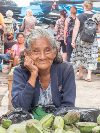 Iquitos, Peru- Mar 27, 2018: Portrait of Peruvian woman selling  bananas on the Belen market, Amazon jungle. South America. Amazonia.のeditorial素材