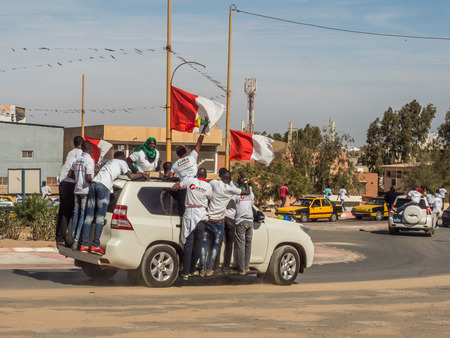 Dakar, Senegal - February 3, 2019: Africans on the car during a street manifestation in the election period. Africa.のeditorial素材