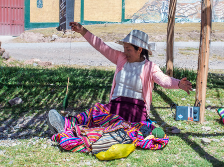 Moray, Peru - May 20, 2016: Quechua woman weaves colorful materiel on looms. South Americaのeditorial素材