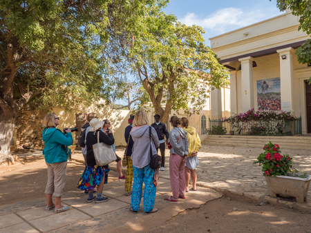 Goree, Senegal- February 2, 2019: Tourists before catholic church  on the Goree island. GorÃ©e. Dakar, Senegal. Africa.のeditorial素材