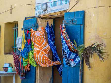 Goree, Senegal - February 2, 2019: Typical souvenirs, colorful dresses and pants from the island of Goree blowing in the wind.GorÃ©e. Dakar, Senegal. Africa.のeditorial素材