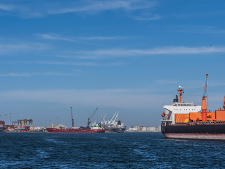 Dakar, Senegal - February 2, 2019: View of the port of Dakar in Senegal with big ships, small boats, cranes and cargos near the quay. Africa.のeditorial素材