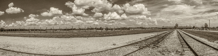 OÅwiÄcim, Poland - June 05, 2019:  Railway tracks and electric fence  in Auschwitz Birkenau Concentration Camp.  Jewish extermination camp. Europeのeditorial素材