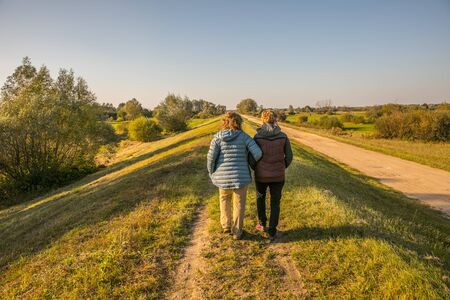 Mature women walking on embankment over the Vistula river bankの写真素材