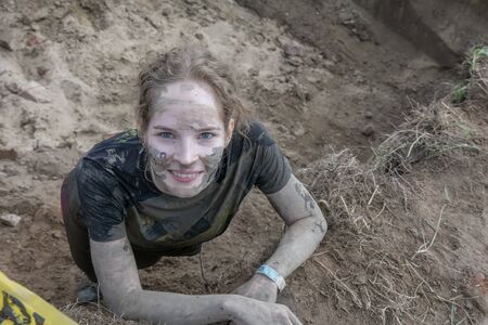 Portrait of young girl in dirty clothesの写真素材