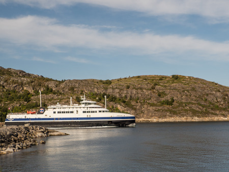 Bodo, Norway - August 20, 2019: View for  Norwegian ferry sailing  from Bodo to Moskenes on the background of large rocks in Bodo. Nordland. Europe. Lofoten Gateのeditorial素材