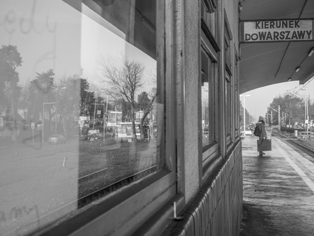 Józefów, Poland - November 23,  2017: Lonely woman on a railway station in Jozefow, 'Direction Warsaw'のeditorial素材