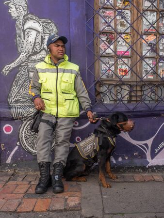 Bogota, Colombia - September 13, 2013: Policeman with dog on the street of Bogota. Plazoleta de...