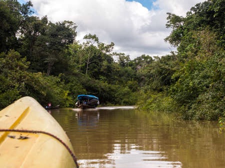 Amazonia, Brazil  - Nov  29, 2018: Boats pass by on the river in the Amazon basin in the Amazon...