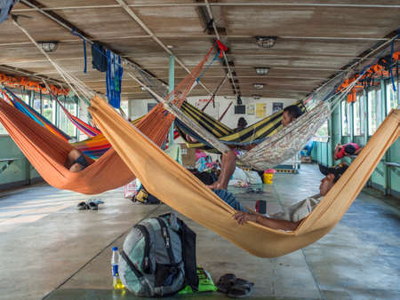 Amazon River, Peru - Sep 19, 2019: People  on the hammocks on the cargo boat. Amazonia, trail from Santa Rosa to Iquitos. South Americaのeditorial素材
