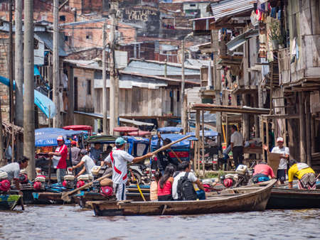 Belen, Peru- Dec 2019: People on the boats between floating houses in the floodplain of the Itaya River, poorest part of Iquitos - BelÃ©n. Venice of Latin America. Iquitos, South America, Amazoniaのeditorial素材