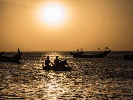 Sunset on the Atlantic coast in Africa and the silhouettes of a fishing boats on the water, Senegal, Africaのeditorial素材