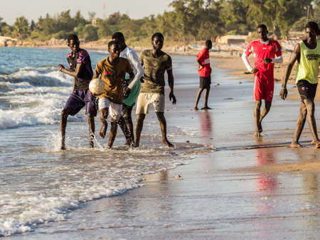 Senegal, Africa - January 26, 2019: Young african boys are play football on the beach. Senegal. Africa.のeditorial素材