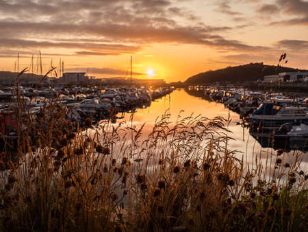 Ronvikleira, Bodo, Norway - August 18, 2019: View of the marina and sailing boats during the sunset. Yacht port located in the port of Bodo. Nordland. Europe. Gate to Lofotenの写真素材