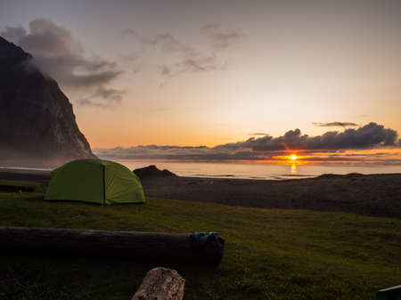 Green tent on the camping and the view for Kvalvika Beach, Lofoten, Norwayの写真素材