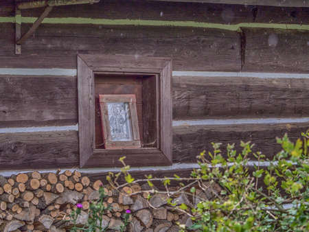 Zyndranowa, Poland - August 13, 2017: Small chapel on the wall of a Lemko wood house in Zyndanowaの写真素材