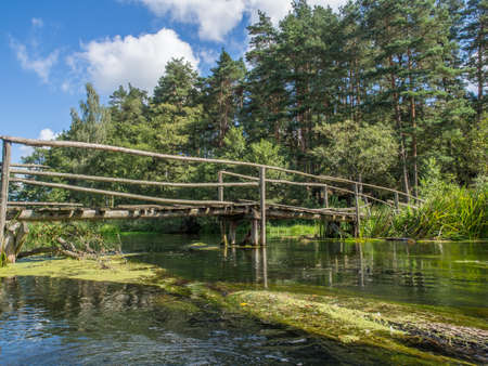 Small, wooden bridge on the Wda river in Poland