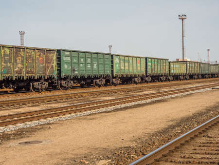 Klaipeda, Lithuania - April 07, 2018: Green wagons of a cargo train on the train station in Klaipeda