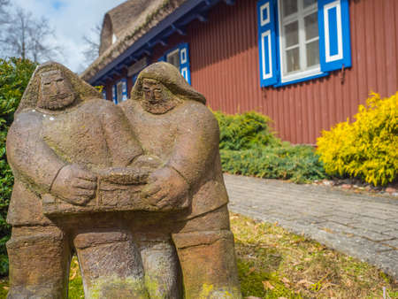 Nida, Lithuania - April 06, 2018: A stone sculpture in front of the red wooden house on a headland in the town of Nida, Curonian Spitのeditorial素材