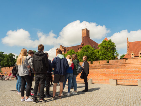 Malbork, Poland - May 22 2019: Tourists looking at Teutonic Castle in Malbork (Marienburg) in...