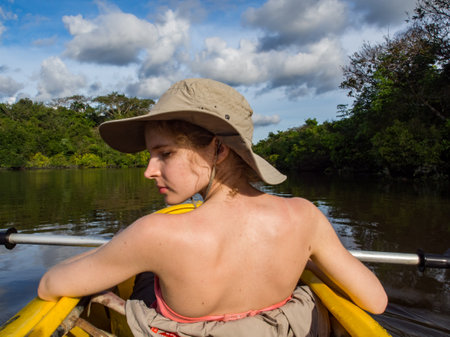 Jangle, Brazil - May 8, 2016: Young women kayaking between the treetops in the flooded jungle, Amazonia, South America.の写真素材