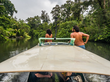 Kensi, Arguni, Indonesia - February 06, 2018: Tourists on a motor boat in the middle of the rain forest during a trip to the village of Kensi on West Papua, Indonesiaのeditorial素材