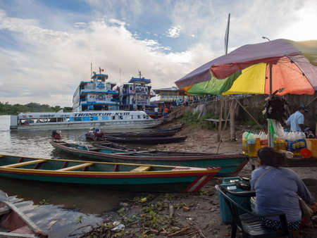 Caballococha, Peru - May 04, 2016: Ferry boats and other small wooden boats in the port in a small town on the bank of the Amazon River, Amazonia, South America.のeditorial素材