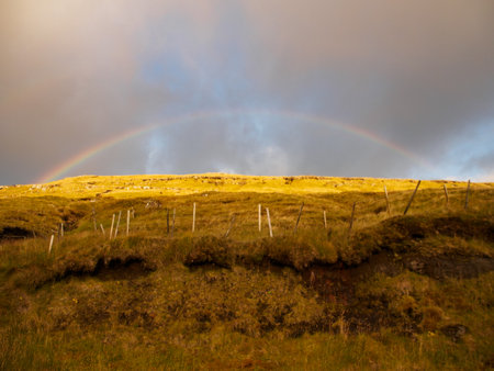 View with the rainbow during golden hours for to the peaks of Eysturoy Island. Faroe Islands. Denmark. Northern Europeの写真素材