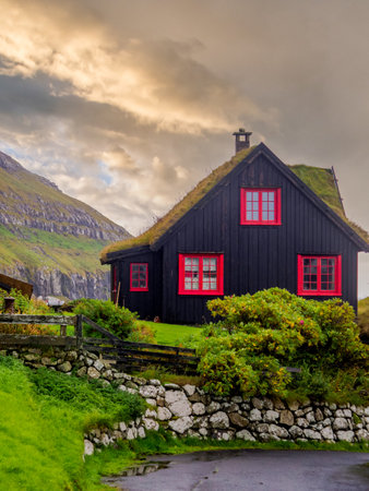 KirkjubÃ¸ur, Faroe Islands - October 2020: Typical wooden turf house with red window on Streymoy Island., Denmark, Northern Europeのeditorial素材