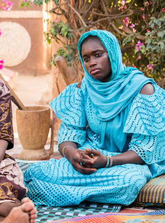Senegal, Africa - Jan, 2019: Portrait of a beautiful Senegalese woman in a traditional costume called 'boubou' and a swing on her headのeditorial素材