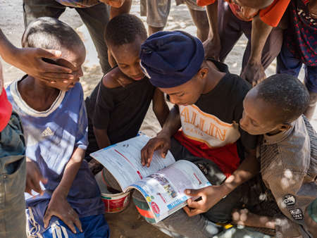 Senegal, Africa - Jan 2019: African children who are thirsty for knowledge read a textbook on the...