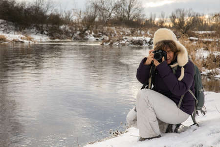Woman making the pictures on the Bank of the Vistula river during the winter. Poland. Natura 2000の写真素材