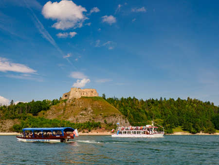 Poland - Aug 2020: View of the Czorsztyn Castle and a ship with tourists from the deck of a boat sailing on the Czorsztyn Lake. Podhale. Poland. Europeのeditorial素材