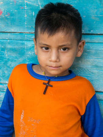 San Pedro, Brazil - September 2017: Portrait of a boy with a wooden cross around his neck - an inhabitant of the Amazon rainforest. Javari Valley. Amazon. Latin Americaのeditorial素材