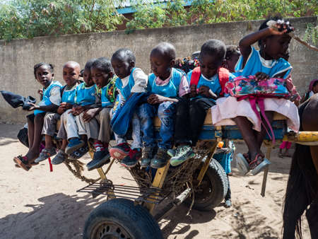 Senegal, Africa - Jan 2019: Transport of African children on the cart from school - african school bus. Education happiness symbolのeditorial素材
