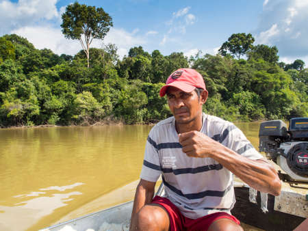 Jungle, Brazil - Dec 7, 2017: Portrait of a man with a red skin in the Amazon jungle. Javari Valley. Amazon. Latin Americaのeditorial素材