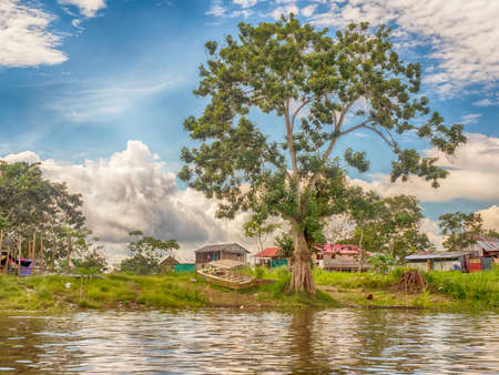 Isla de La Fantasia, Leticia, Colombia - Nov 2019: Typical wooden cottages on the stilts on the Fantasy Island in the small village in Amazon rainforest. Amazon. South America.のeditorial素材