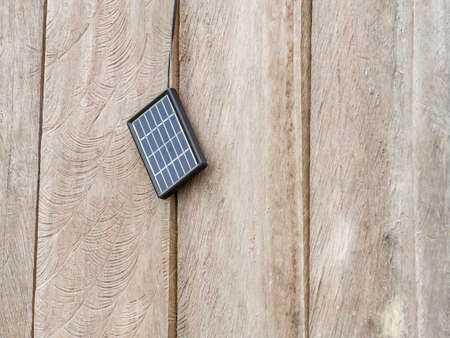 Small solar battery hangs on the wall of a wooden house in a small village on the Amazon River. South America, Amazoniaの写真素材