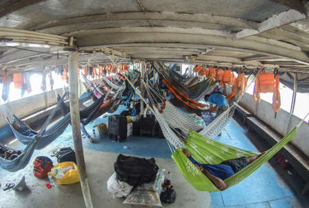 Amazon River, Peru - Dec ,, 2019: Many beautiful, colorful hammocks on the cargo boat. Amazonia, trail from Santa Rosa to Iquitos. Amazon, Peru. South Americaのeditorial素材
