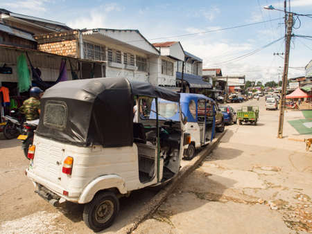 Leticia, Amazonas, Colombia, Dec, 2017: Various rickshaws, motors and cars on a street of a small town. Amazon. Latin America. Colombiaのeditorial素材