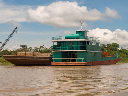 Santa Rosa, Peru - September 2017: Tree from amazon rainforest sawmill being transported on boat....