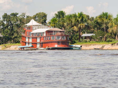 Iquitos, Peru - December 2017: Luxury cruise ship sailing on the Amazon, with cabins with climate, moored at the shore on the Nanay River.のeditorial素材