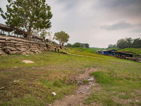 Leticia, Colombia - Mar 2018: Wooden boats, floating houses and embankment in Leticia Harbor on the Amazon during the low season. Amazon. South America.のeditorial素材