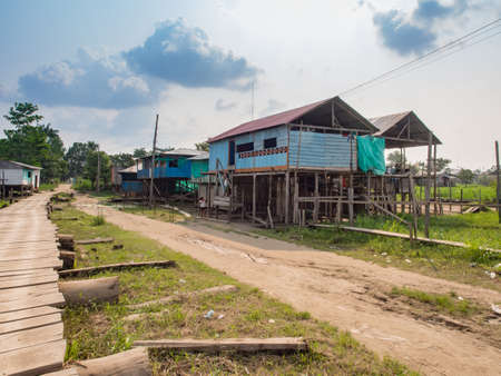 Santa Rosa, Peru- Sep, 2017: Wooden houses in the small villege on the bank of Amazon River during the low season. Amazon. South America.のeditorial素材